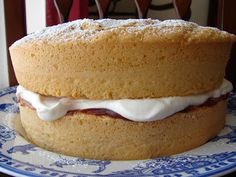 a cake sitting on top of a blue and white plate with icing around it