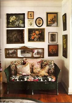 a living room filled with lots of pictures on the wall above a couch and coffee table