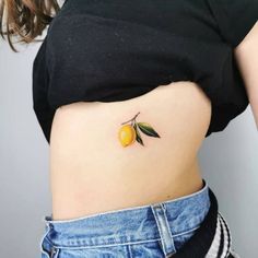 a woman's stomach with an orange tattoo on her left side, and the bottom half