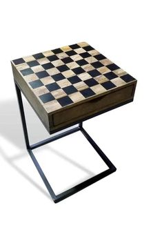 a wooden table with a checkerboard design on the top and metal frame legs