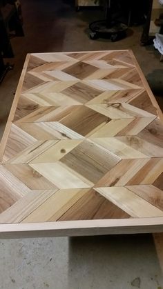 a wooden cutting board sitting on top of a table in a room filled with tools