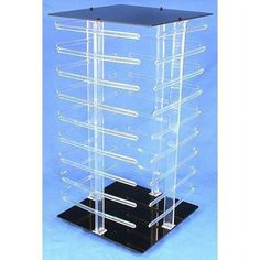 a clear acrylic display case on a black base with six trays in it