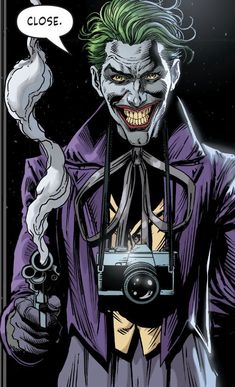 the joker is holding a camera in his hand