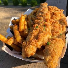 fried fish and french fries on a picnic table