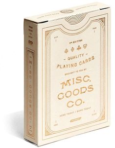 a playing card box with the words music goods co written on it and gold lettering