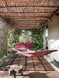 a hammock hanging from the roof of a house