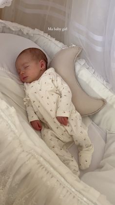 a baby is sleeping in a white crib