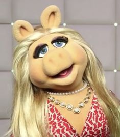 the miss piggy is dressed in red and white