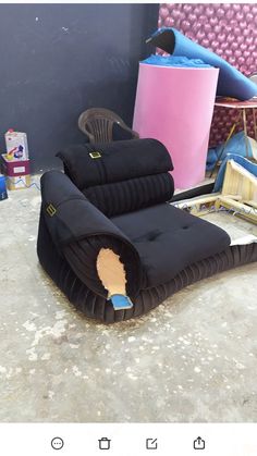 a couch that has been placed on the ground next to some other furniture and items