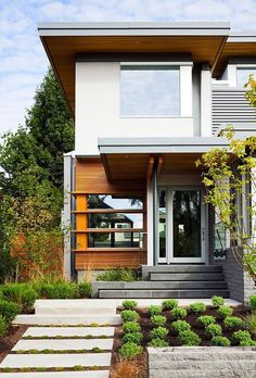 a modern house with landscaping in the front yard