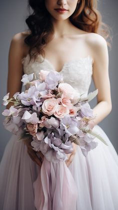 a woman holding a bouquet of flowers in her hands