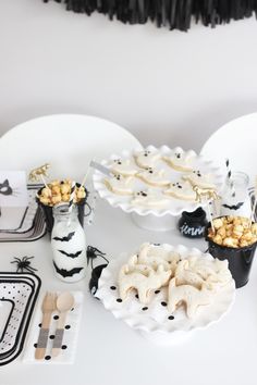 a white table topped with plates and desserts