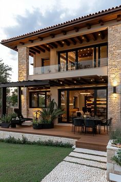 a modern house with an outdoor patio and dining area