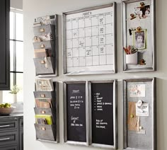 a kitchen wall with magnets on it and a calendar attached to the wall