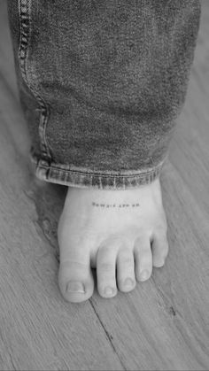 a black and white photo of a person's foot with the word love on it