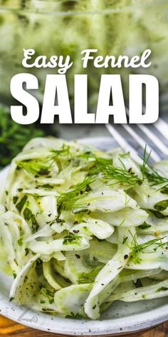 an easy fennel salad is served on a white plate with a fork in it