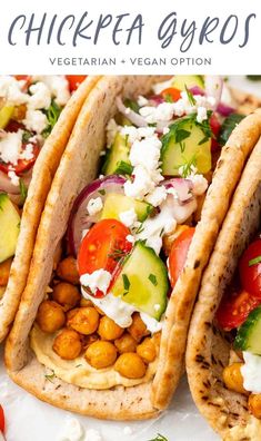 chickpea gyros with vegetables and feta cheese on top, sitting on a white plate