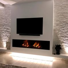 a modern living room with a flat screen tv above the fireplace