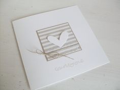 a white card with a heart on it