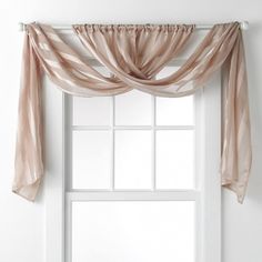 an open window with sheer curtains hanging over it