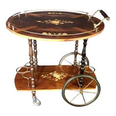 an antique wooden serving cart with wheels