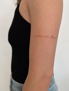 a woman with a tattoo on her arm that says love is in the air,