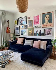 a living room filled with furniture and lots of pictures on the wall above it's couch