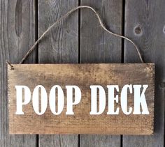 a wooden sign that says poop deck on it