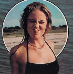 a woman making a funny face while standing in the water