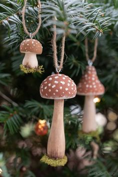 three small mushrooms hanging from a christmas tree