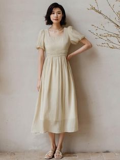 Calf-length, A-line dress. Square neckline and short puff sleeves. Gathers at waist and a flared skirt. Back zip. Lined.- Midi- Short sleeve- A-line Spring Beige A-line Puff Sleeve Dress, Beige Fit And Flare A-line Midi Dress, Beige A-line Fit And Flare Midi Dress, Solid A-line Dress With Gathered Sleeves, Pleated Midi Dress With Square Neck, Fitted A-line Puff Sleeve Dress, Square Neck Pleated Midi Dress, Beige A-line Midi Dress With Pleated Waist, Modest Fitted Puff Sleeve Summer Dress