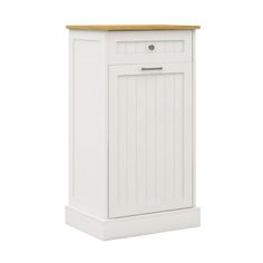 a white cabinet with a wooden top sitting on a white floor next to a wall