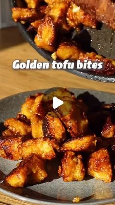 two plates filled with fried food on top of a wooden table next to each other