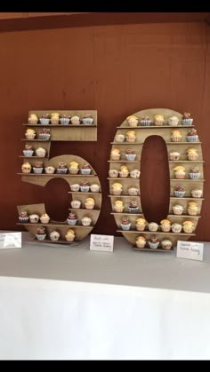 the number 50 is made out of cupcakes and sits in front of a table