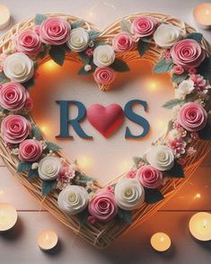 a heart - shaped basket with roses and candles around it that says ros in the center