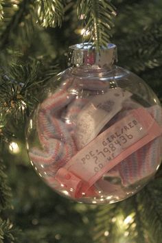 a glass ornament hanging from a christmas tree