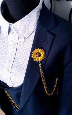 Looking for a distinctive and long-lasting accessory that effortlessly elevates your style? It's time to discover our Sunflower Lapel Chain Pin! It is a meticulously handcrafted masterpiece made from high-quality alloy and steel. This versatile accessory is designed to complement any outfit, whether it's adorning your lapel or adding a touch of charm to your shirt. Whether it's embellishing your lapel or bringing some flair to your shirt, this adaptable item is made to match any ensemble. It is more than just an accessory; it's a symbol of elegance and sophistication. Perfect as a gift for friends, family, and loved ones, this Sunflower Lapel Chain Pin is ideal for daily wear, weddings, and various occasions. Its timeless design allows you to express your style and make a statement. Enhanc Mens Sunflower And Burgunfy Pin For Suits, Flowers For Mens Suit, Elegant Adjustable Sunflower Design Jewelry, Elegant Adjustable Sunflower Jewelry, Elegant Lapel Pin With Chain As Gift, Gold Brooches With Chain For Gifts, Gold Chain Brooch For Gifts, Formal Flower-shaped Metal Jewelry, Handmade Elegant Gold Lapel Pin