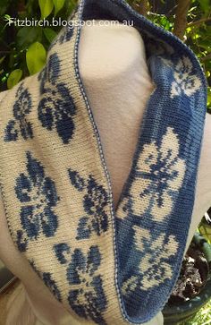 a blue and white knitted scarf on top of a mannequin's head