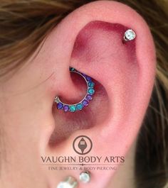 a close up of a person's ear with a piercing