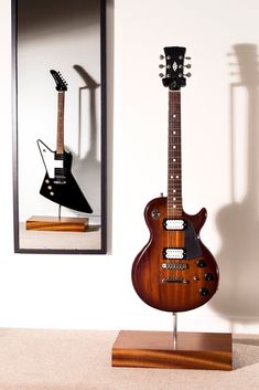 an electric guitar is on display in front of a mirror