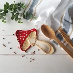 two wooden spoons are next to a red and white polka dot covered dish cloth