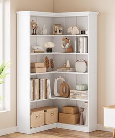 a white book shelf filled with lots of books next to a potted plant on top of a hard wood floor