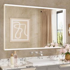 a bathroom with a sink, mirror and flowers in the vase on the counter top