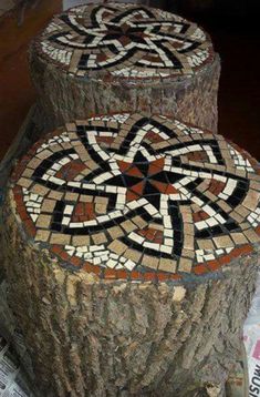 two wooden stumps with mosaic designs on them