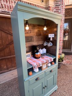 a display case with pumpkins on it in front of a brick building