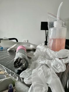 a table that has some items on top of it and plastic bags around the table