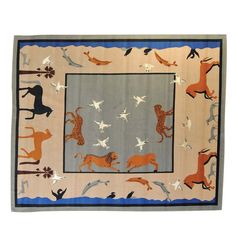 a rug with horses and dogs on it, in the shape of a rectangle