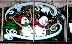 two snowmen painted on the side of a building