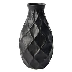 a black vase sitting on top of a white table