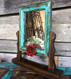 an old wooden mirror with a red bow on it